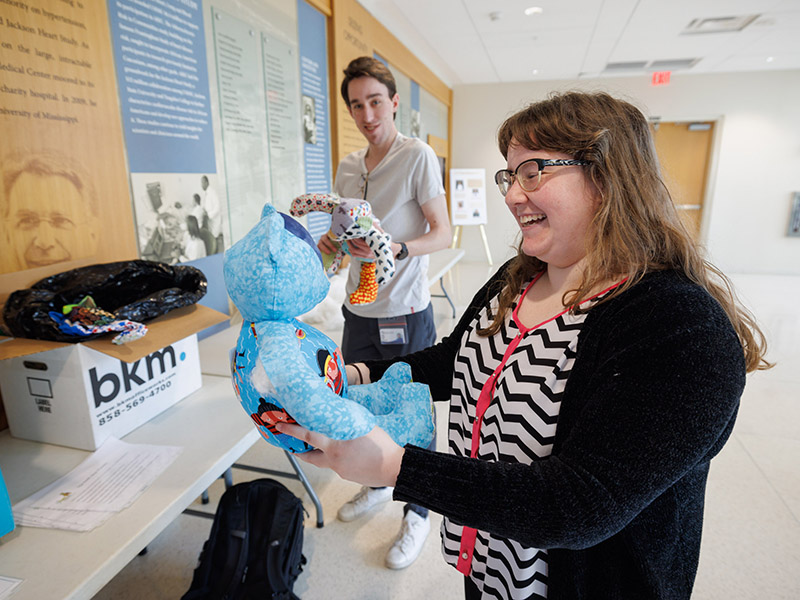 Medical student Hannah O'Bryan admires a freshly stuffed bear as classmate James Lemon works on his own.